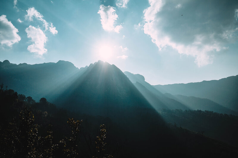 Mountain Peak with Sun Rays — Blue, Dramatic