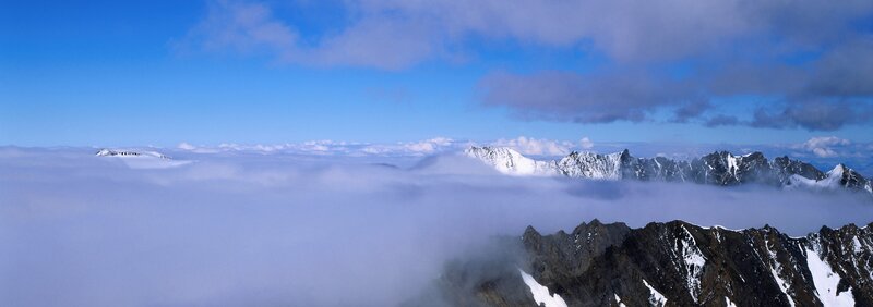 mountain peaks above clouds