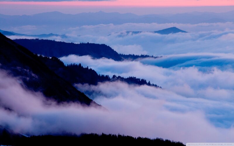 mountain peaks above clouds