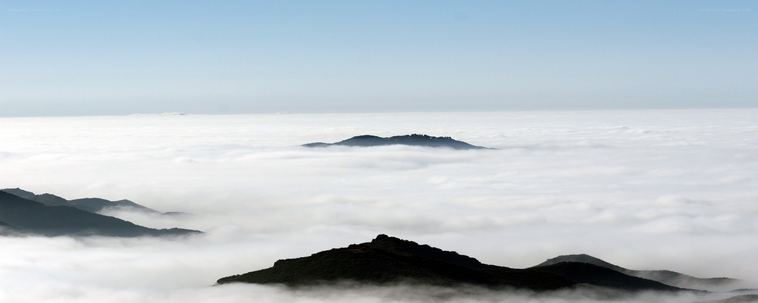 mountain peaks above clouds