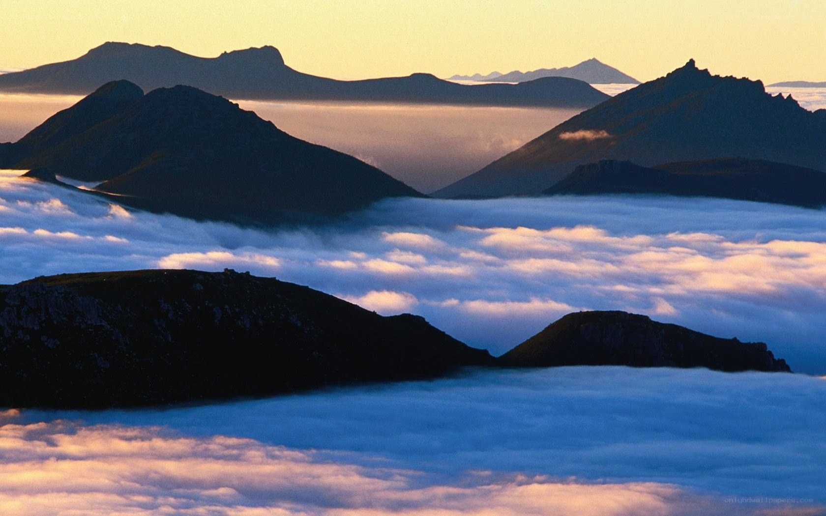 mountain peaks above clouds