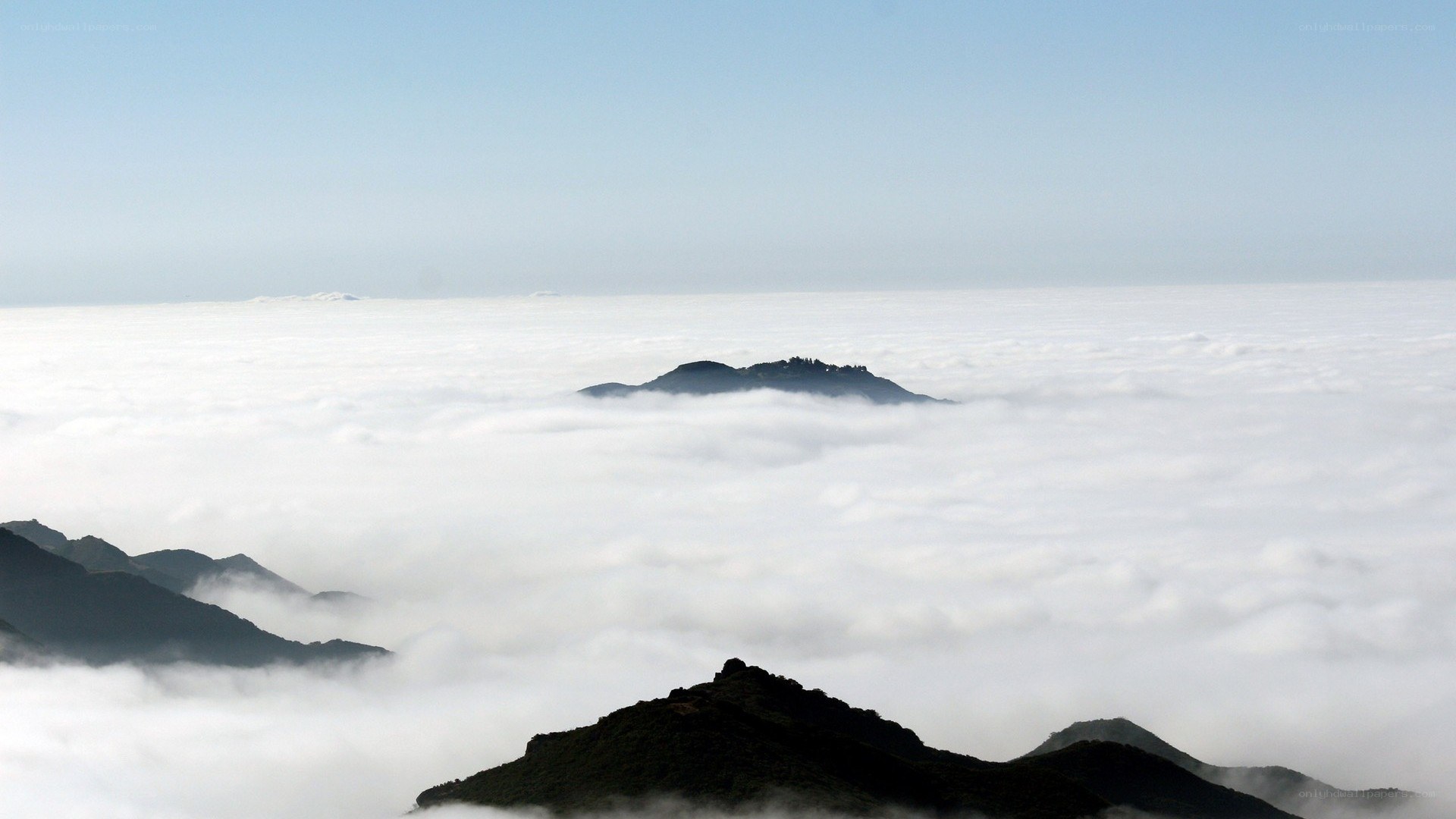 mountain peaks above clouds