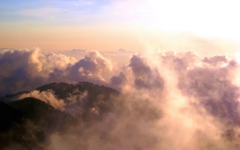 mountain peaks above clouds