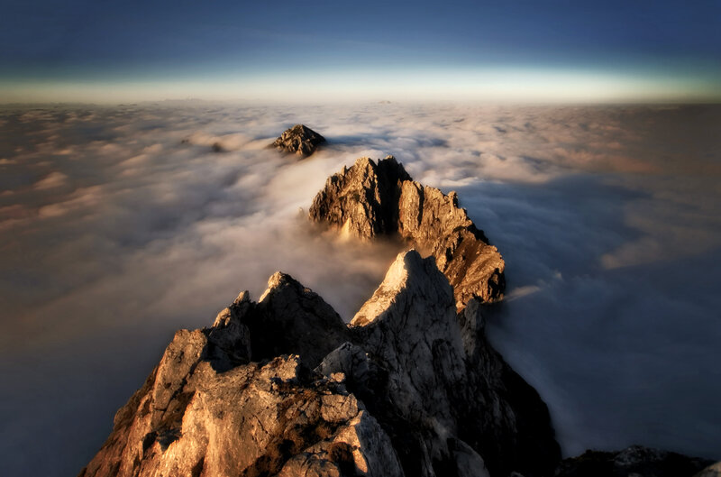 Mountain Peaks Above Clouds — Blue, Dramatic, Sunrise, Photograph, Sky, Rocks