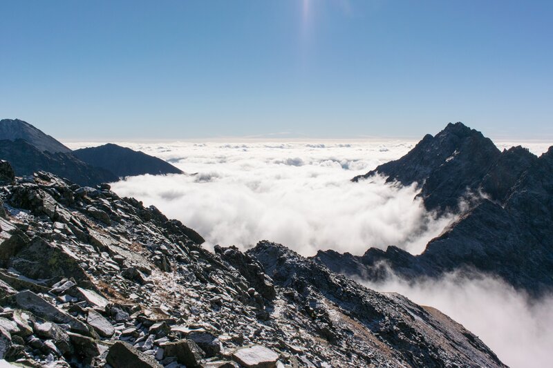 Mountain Peaks Above Clouds — Blue, Serene, Afternoon