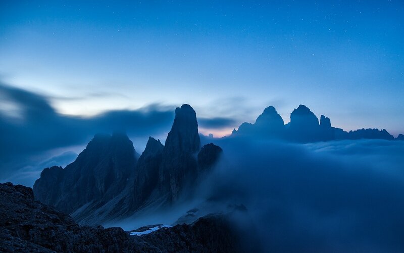 Mountain Peaks Above Clouds — Blue, Serene, Night, Photograph