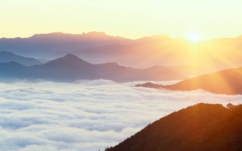 Mountain Peaks Above Clouds — Orange, Serene