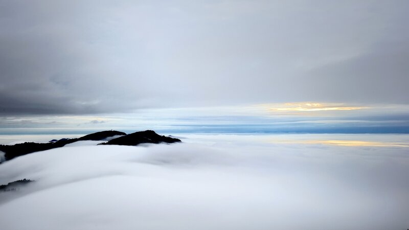 Mountain Peaks Above Clouds — White, Serene, Sunrise
