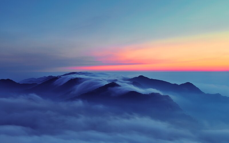 Mountain peaks above sea of clouds