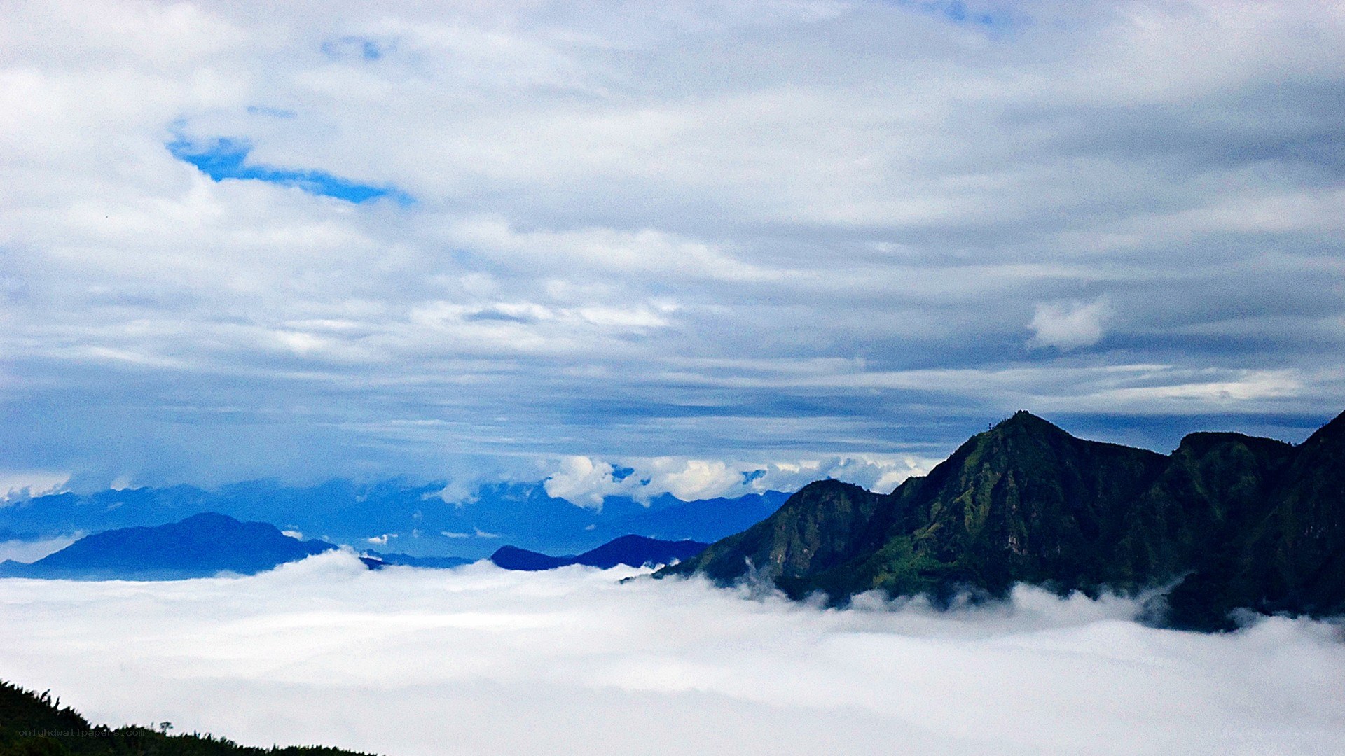 mountain peaks above the clouds