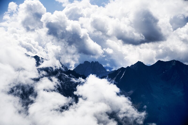 Mountain Peaks Through Clouds