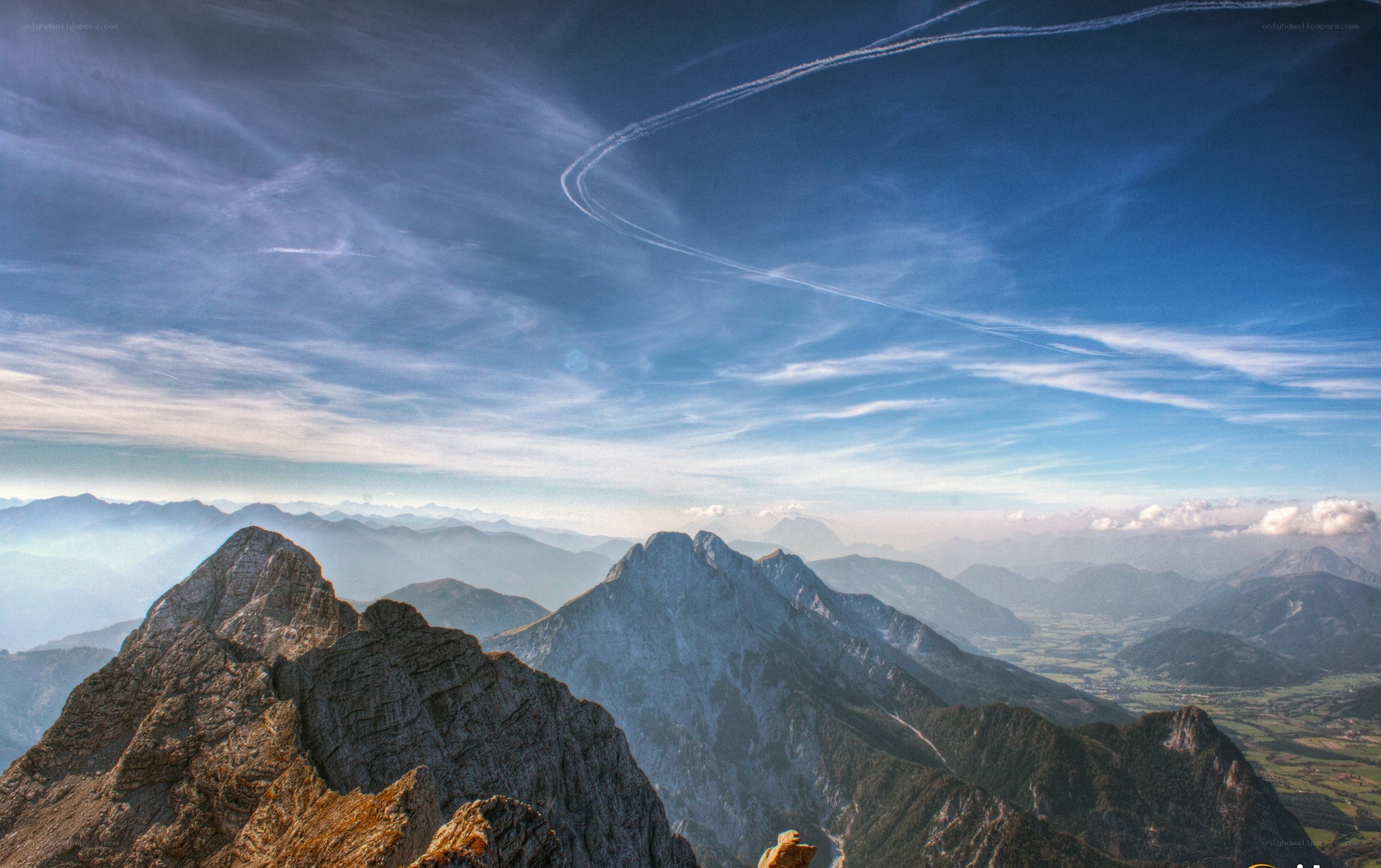 Mountain peaks under a blue sky