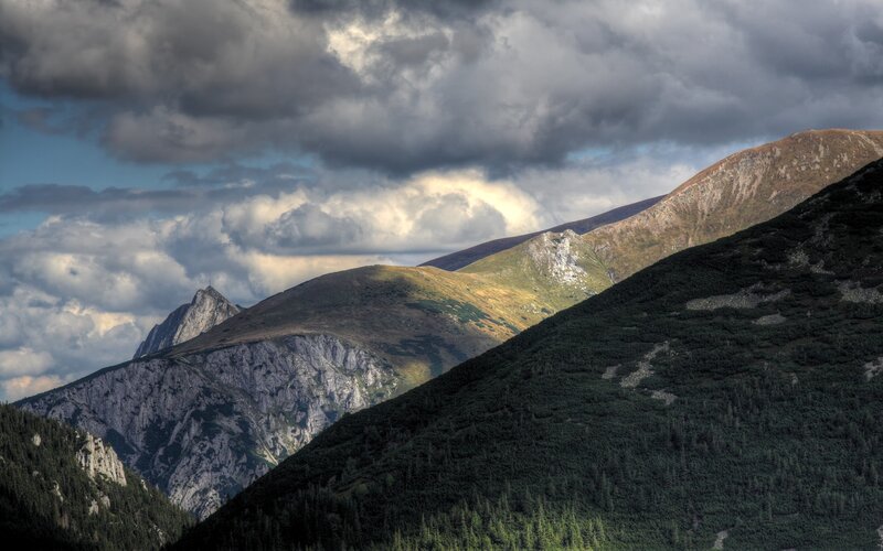 Mountain peaks under cloudy sky