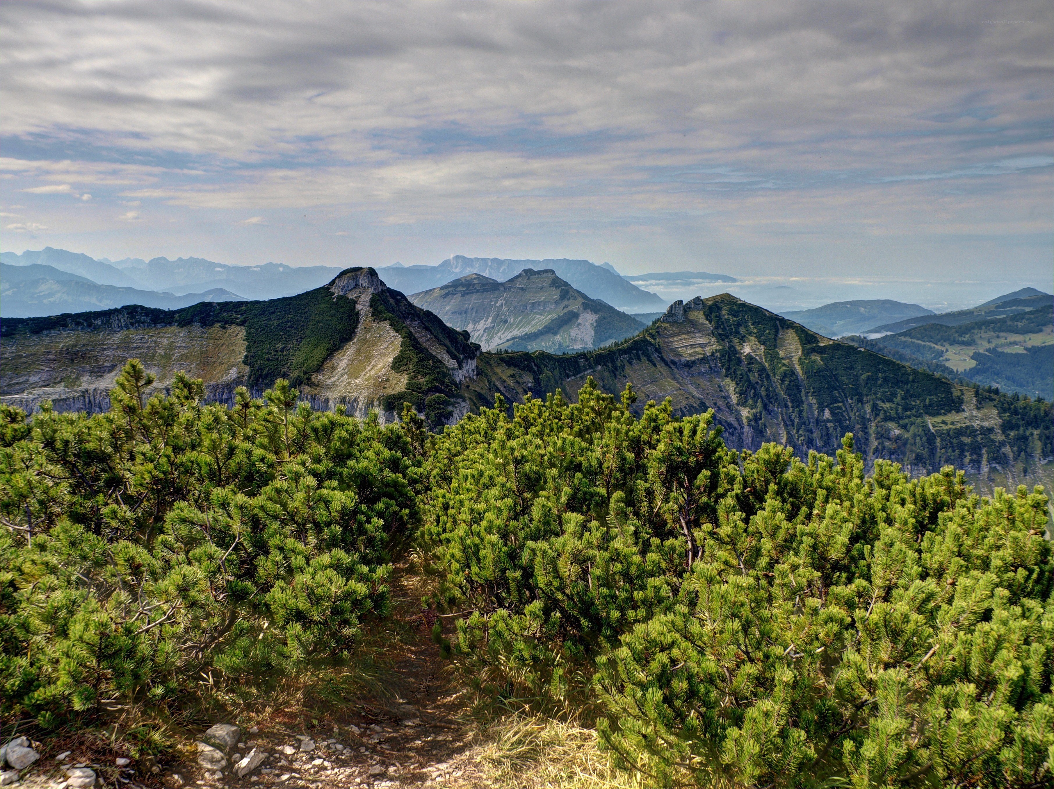 Mountain peaks under cloudy sky