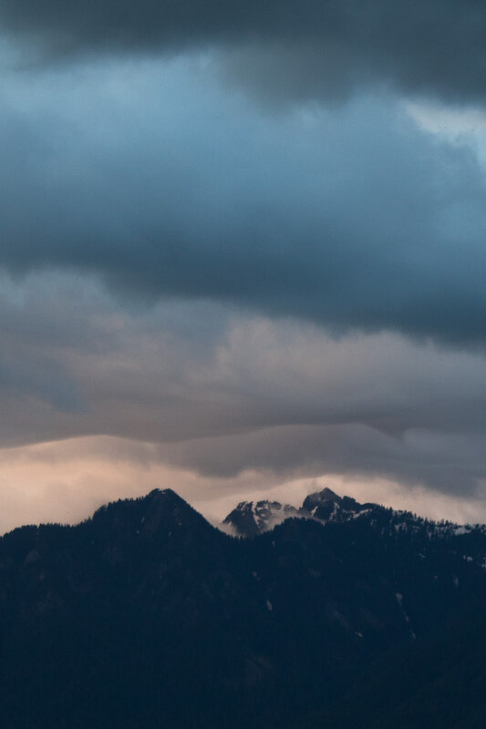 Mountain Peaks under Storm Clouds — Blue