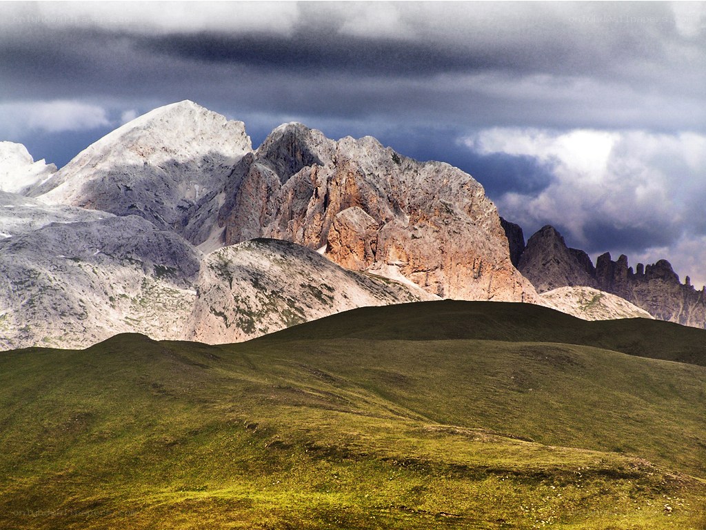 Mountain peaks under stormy sky