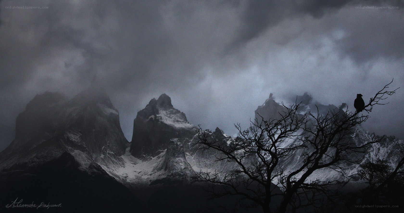 Mountain peaks under stormy sky
