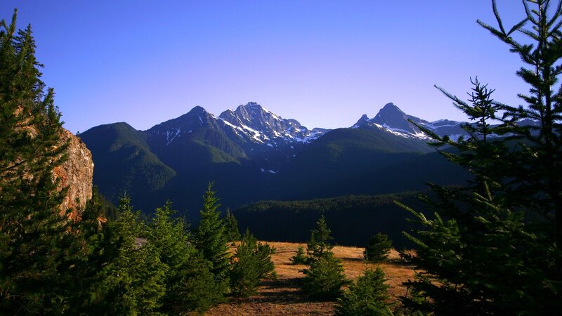 Mountain peaks with snow and trees