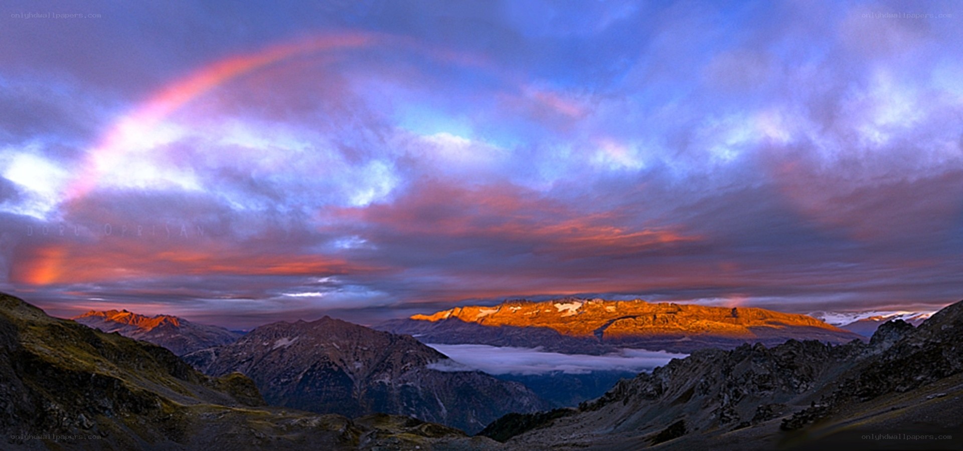 Mountain rainbow at sunrise