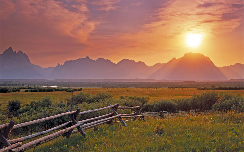 Mountain Range at Sunset — Orange, Serene, Photograph, Fence, Field, Sun, Purple, Green