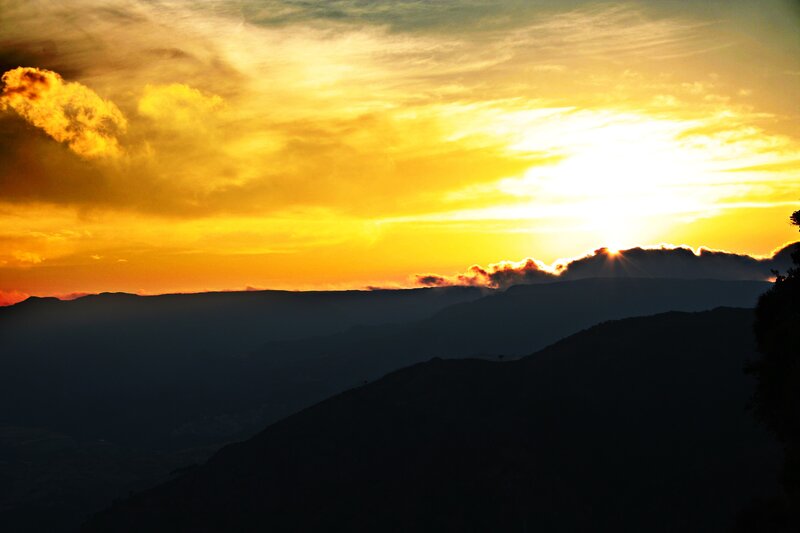 Mountain Range at Sunset — Yellow, Dramatic, Photograph, Sun, Clouds, Silhouette