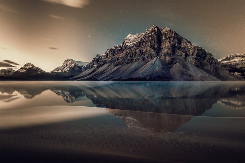Mountain Range Reflection — Brown, Serene, Sunset
