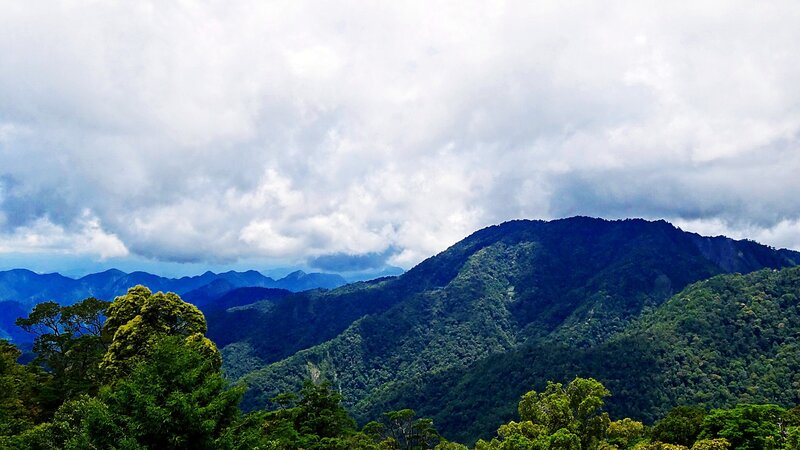 Mountain range under cloudy sky