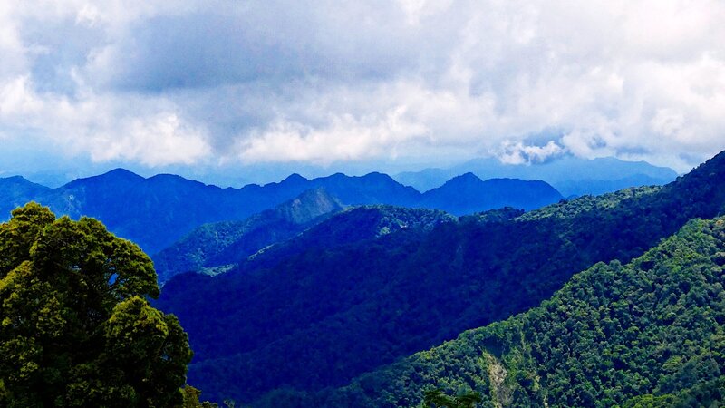 Mountain range under cloudy sky