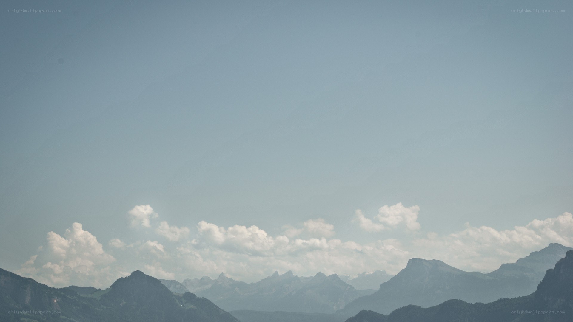 Mountain range under cloudy sky