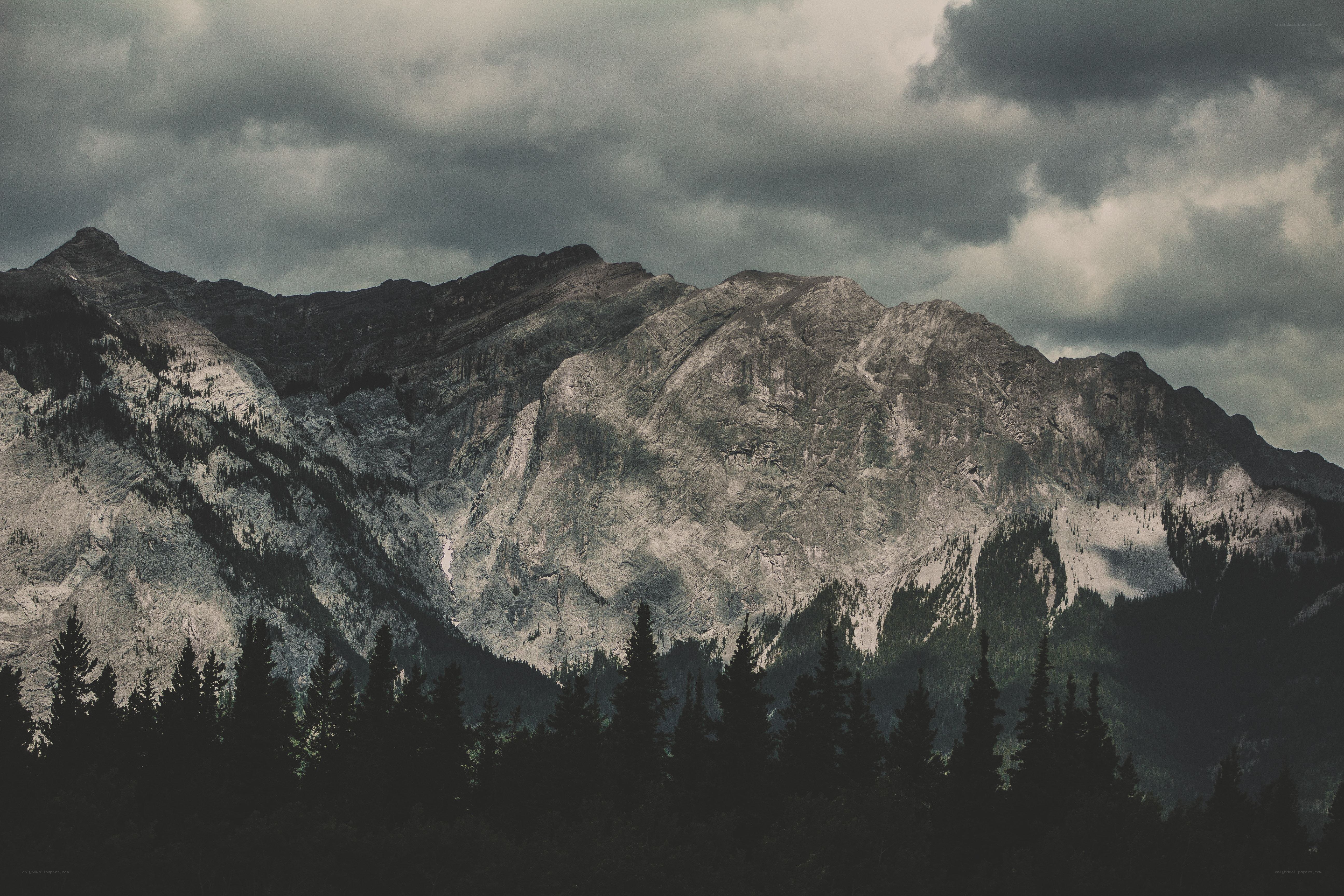 mountain range under cloudy sky
