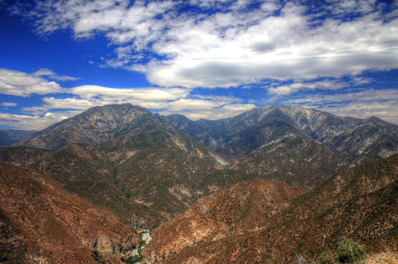 mountain range under cloudy sky