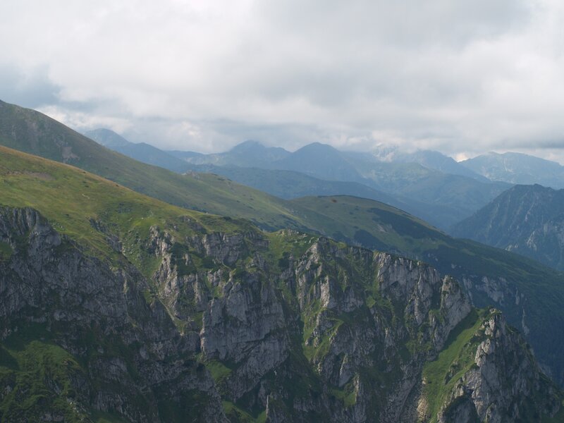 Mountain range under cloudy sky