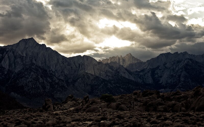 Mountain Range under Cloudy Sky — Gray, Dramatic, Sunset, Photograph