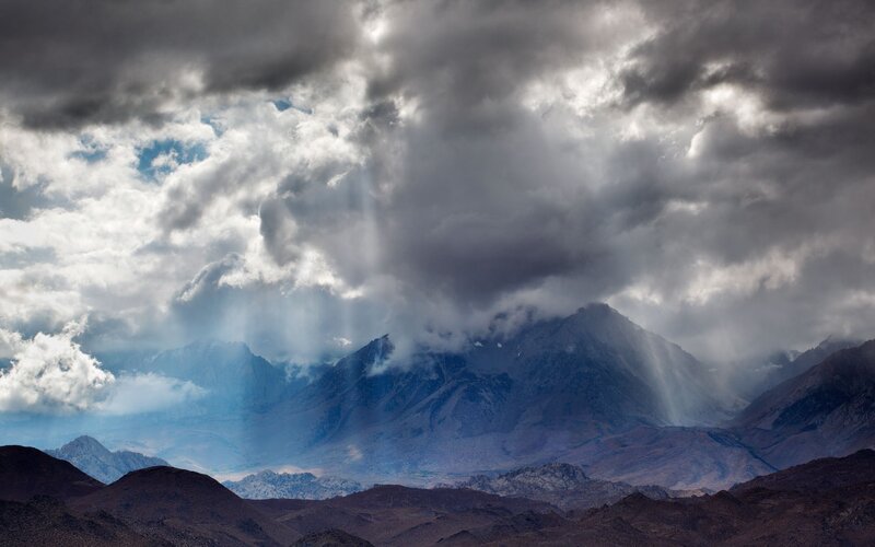 Mountain Range under Storm Clouds — Gray, Dramatic, Photograph, Mountains, Sunlight