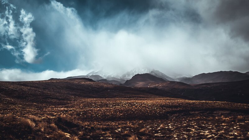 Mountain Range under Stormy Sky — Brown