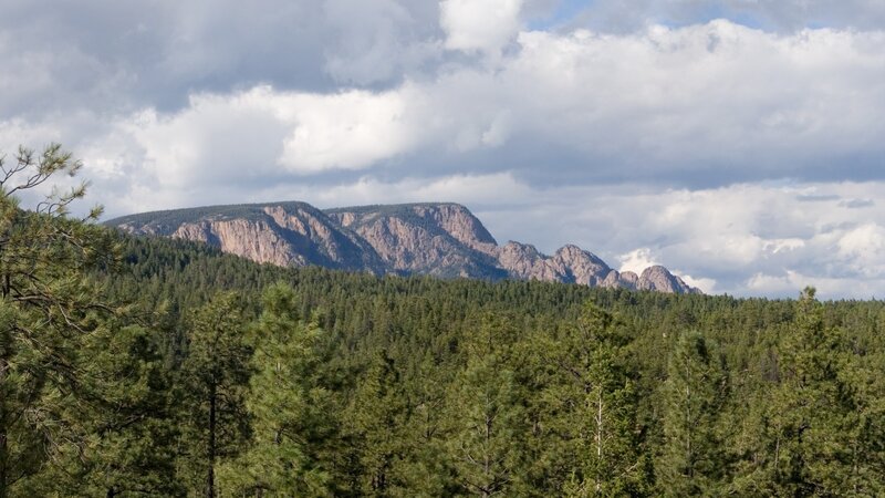 Mountain Range with Forest — Green, Serene, Afternoon, Photograph, Trees, Clouds, Rocky Cliffs