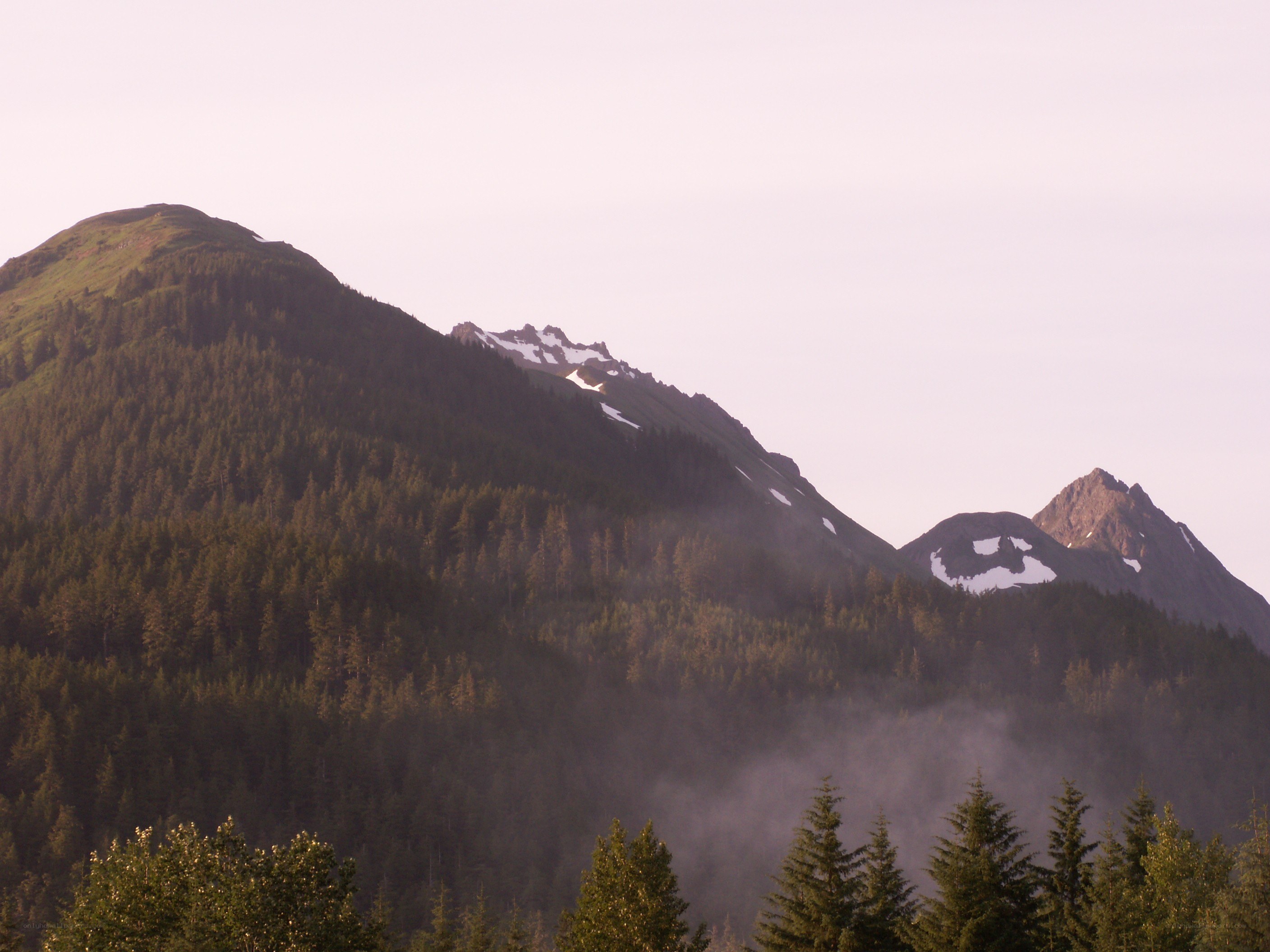 Mountain range with snow patches