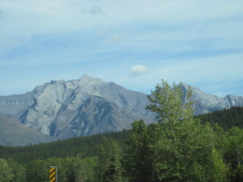 Mountain Range with Trees — Green, Serene, Afternoon, Photograph, Road Sign