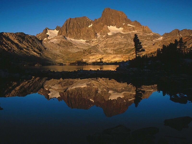 mountain reflected in lake at dawn