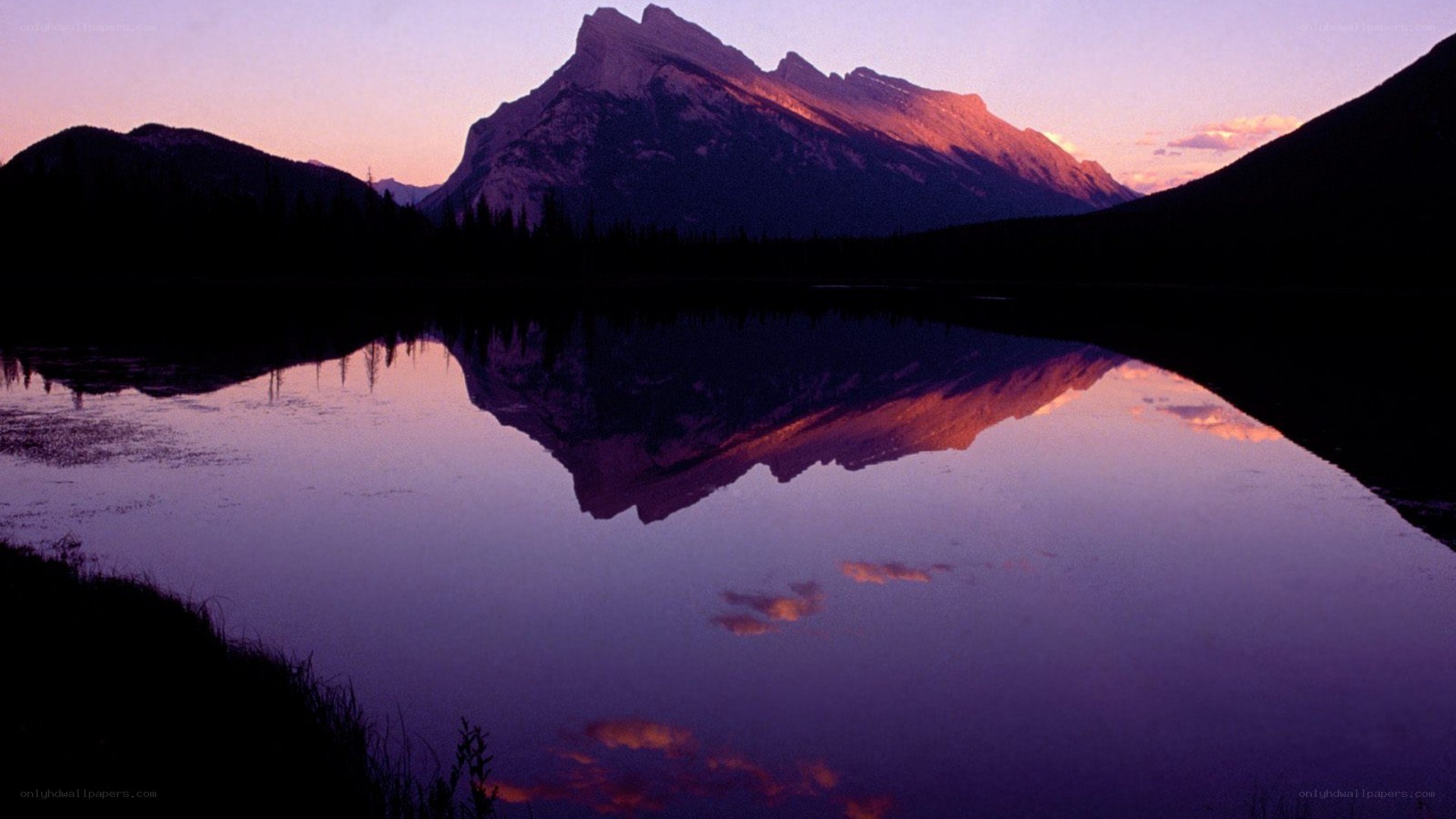 Mountain reflected in lake at dusk