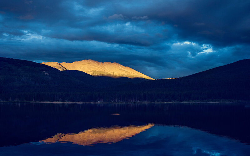 Mountain reflected in lake at dusk