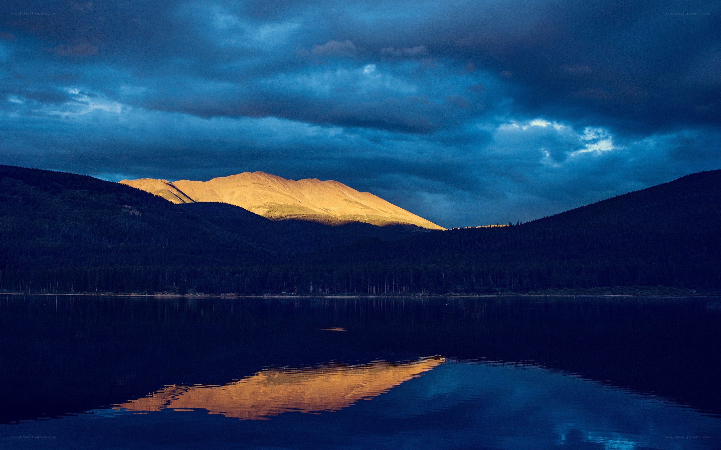 Mountain reflected in lake at dusk
