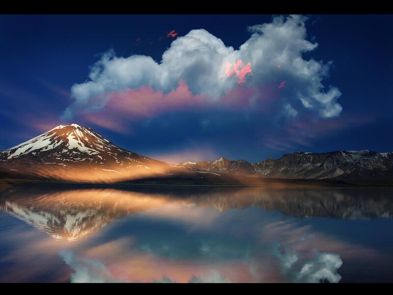 Mountain reflected in lake at sunset