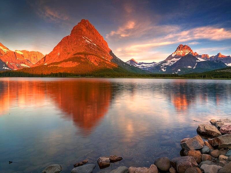 mountain reflected in lake at sunset