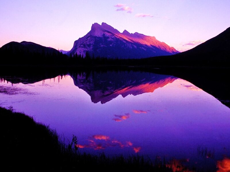 mountain reflected in lake at sunset