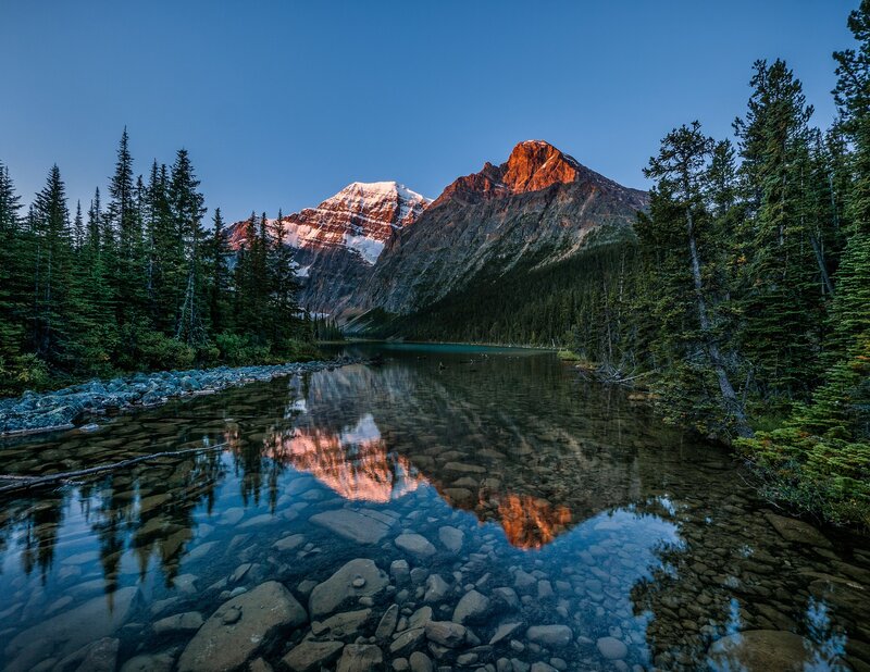 Mountain Reflected in Lake — Blue, Serene, Sunset, Photograph, Trees, Snow, Rocks