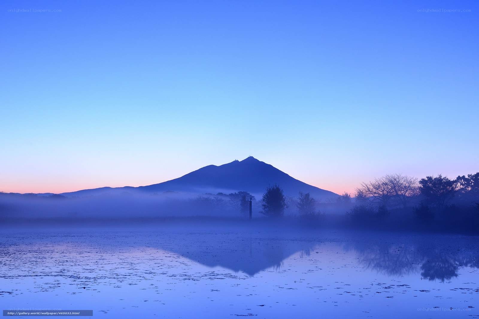 Mountain reflected in misty lake
