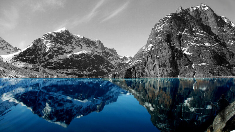 mountain reflection in blue water