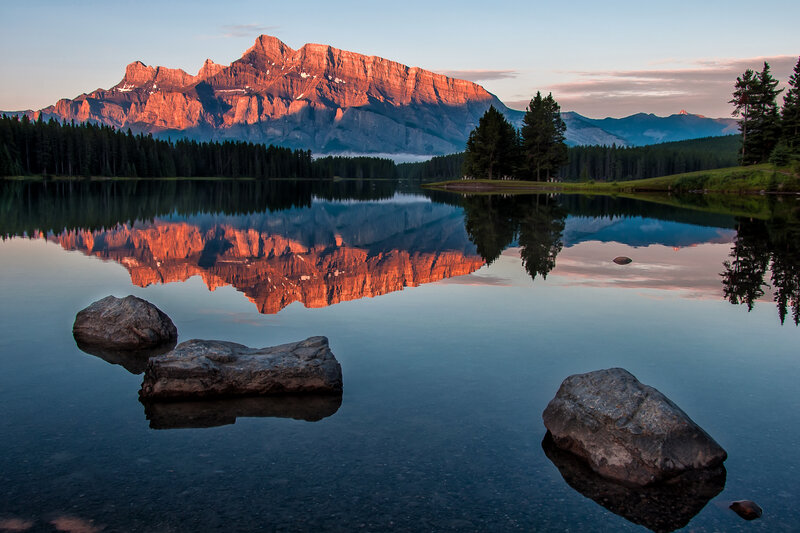 Mountain Reflection in Lake — Blue, Serene, Sunset, Photograph, Trees, Rocks
