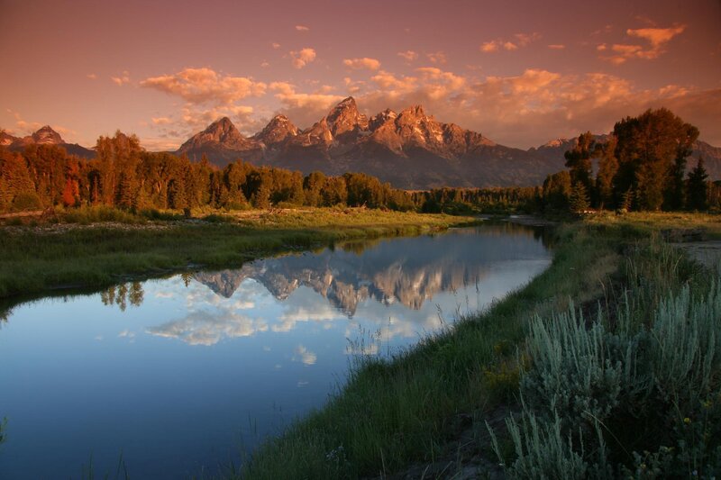 mountain reflection in river at sunset